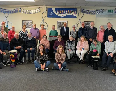 Large group of community participants with drums