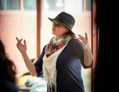 Singer with hat and scarf performing in foyer