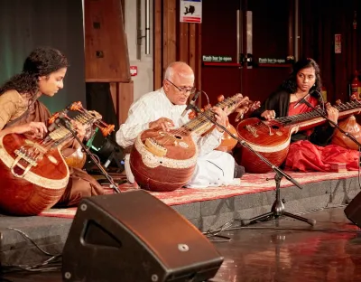 Three musicians playing traditional Indian instuments