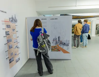 Woman at exhibition reading poster