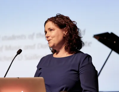 Dr Sandra Joyce speaking at a podium