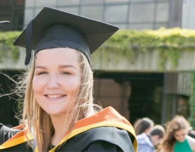 Smiling woman in graduation cap and gown