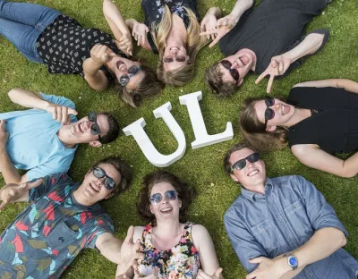 international students enjoying the sun with UL sign