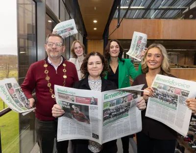 A group holding newspapers at the launch of the Limerick Voice in the UL library