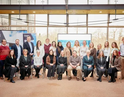 Large group of people posing for photo in an indoor setting