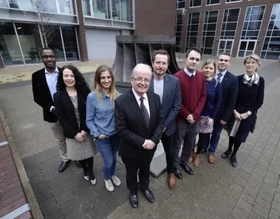 Des Fitzgerald pictured with group of people facing camera