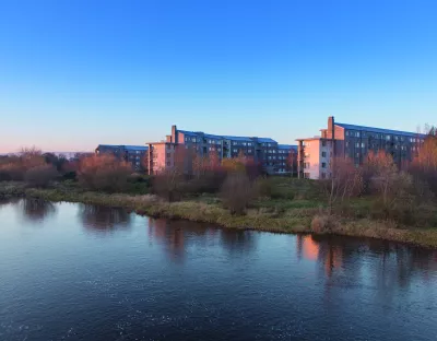 Image shows village on campus across the river