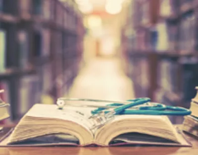  Photo of a book open with a stethoscope on it