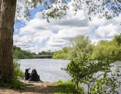 Students looking onto the River Shannon on the University of Limerick campus