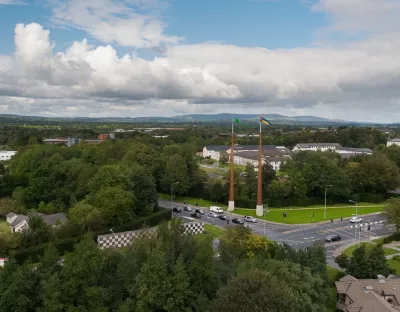 Aerial view of U.L's flagpoles with surrounding campus