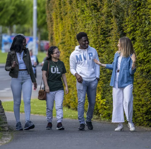 four students walking and chatting together