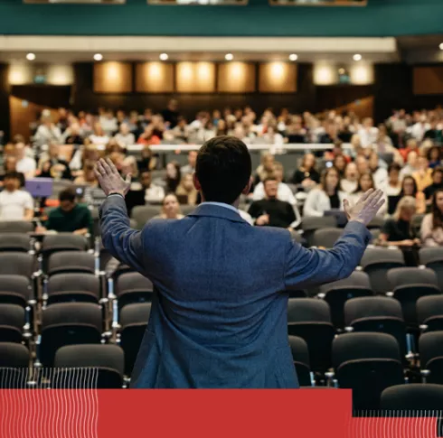 Stephen Kinsella lecturing in a large hall