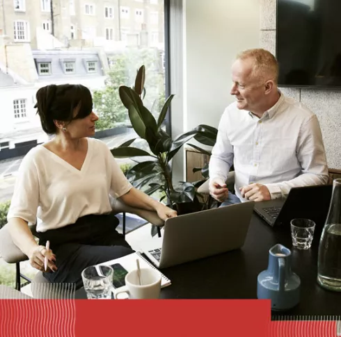 2 people in an office talking