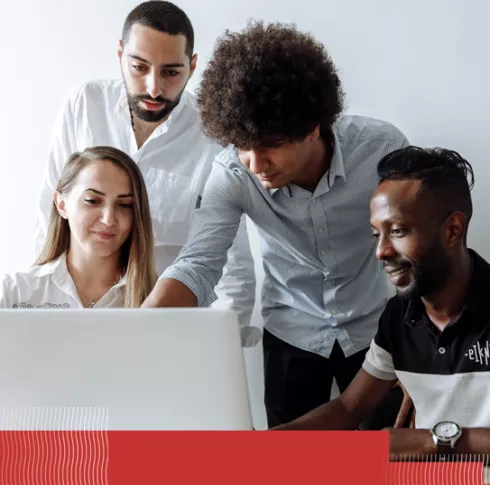 Diverse group looking at a laptop