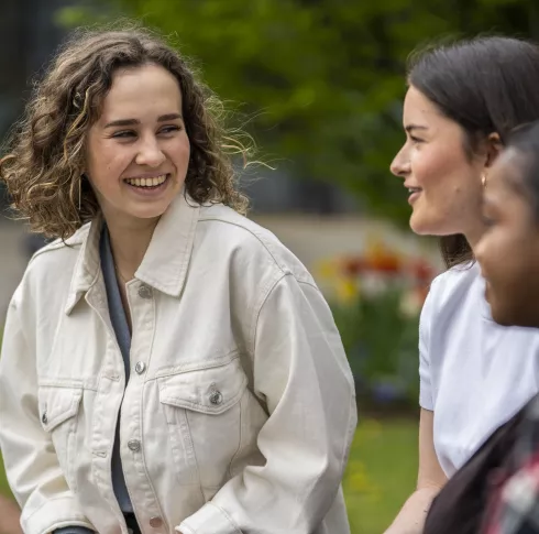 3 students chatting outside