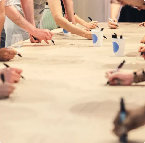 Group of people drawing on table