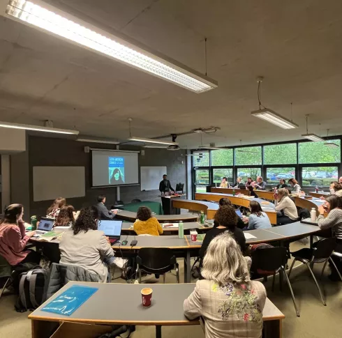 Lecture room with students working at the conference