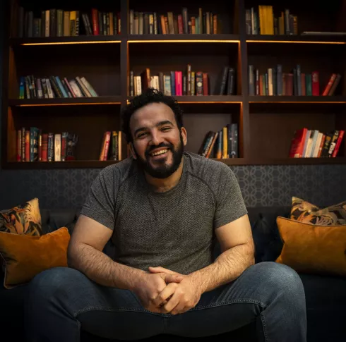 Mostafa Darwish, seated and smiling at camera