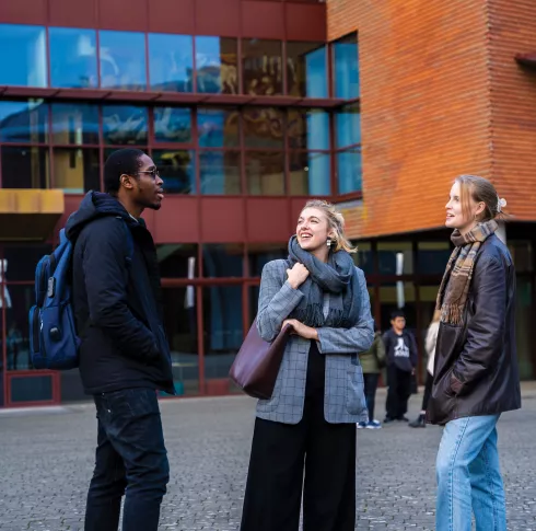 3 Students talking outside IWAMD