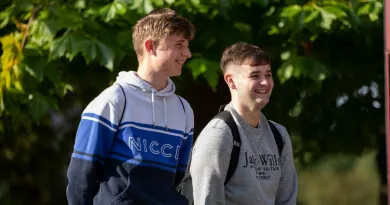 2 students laughing and chatting during orientation