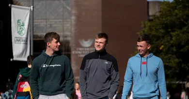 3 students walking and talking during orientation