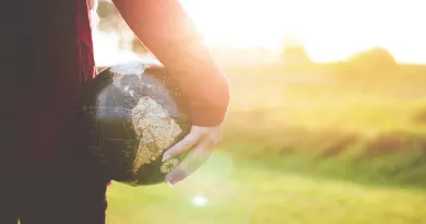 A woman holding a globe