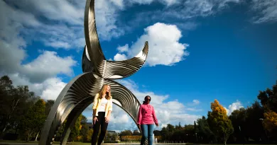 Students in front of schuman building sculpture