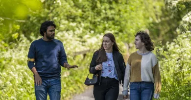 Students walking on the riverbank