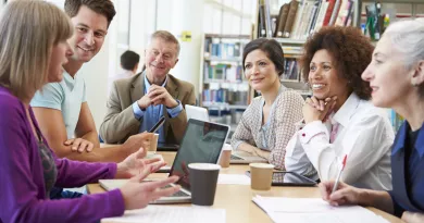 Group of 6 mature students studying and talking