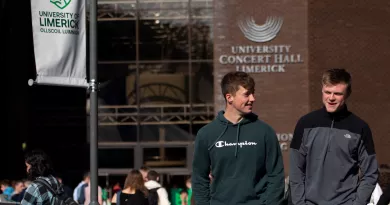 two young men walking outside the foundation building