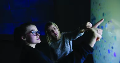 Staff and student working on a screen