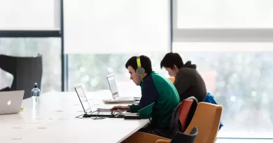 Image of two students on laptops in UL Library