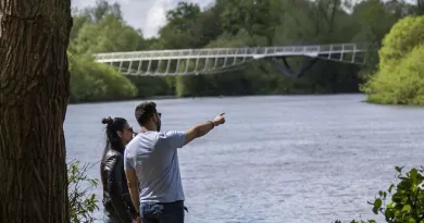 2 people beside the river Shannon looking at the living bridge