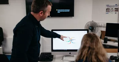 Person pointing to computer screen