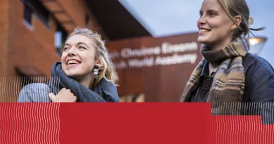 2 young women pictured on front of the UL KBS building