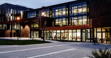 exterior of library building at night with lights on