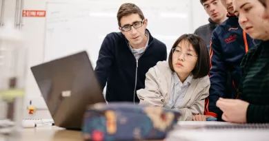 students looking at a laptop 