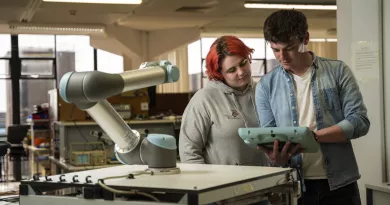 students looking at a tablet in a lab