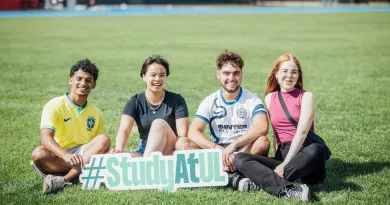 Students holding a #StudyatUL sign before the Speed friending event in September 23 orientation