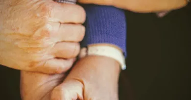 stock image of older persons holding hands