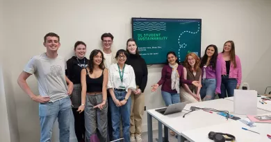 A group of students standing together smiling