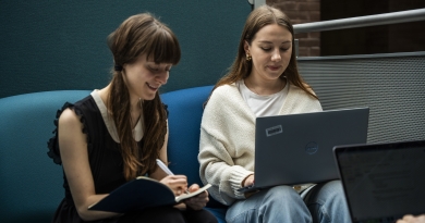 2 students working together on a laptop