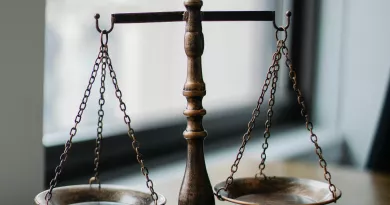 Scales of justice and gavel on a bench