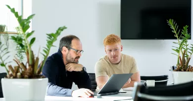 Image of two people looking at a laptop in the Nexus Innovation Centre