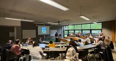 Lecture room with students working at the conference