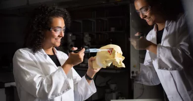 Student injecting into a skull