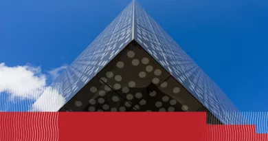 close up view of Bernal building corner with blue sky and clouds