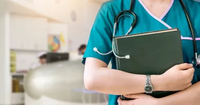 Person with stethoscope and laptop