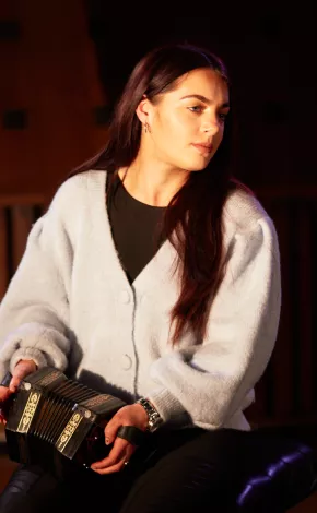 Young woman playing a concertina