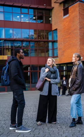 3 Students talking outside IWAMD